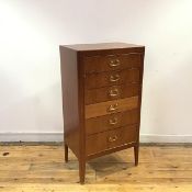 A 1950s mahogany chest of six short drawers with drop gilt metal handles and brass lining, raised on