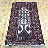 A hand knotted wool rug, of Caucasian design, the ivory field decorated with serrated motifs, within