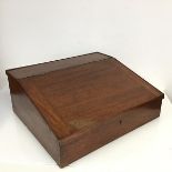 An early 20thc. mahogany writing slope, the hinged top opening to a fitted interior, with two