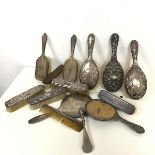 A collection of mostly silver Edwardian dressing table brushes, mirrors and a comb, various patterns