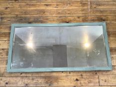 A wall mirror with a mint green painted frame enclosing a bevelled glass with panelled back (62cm