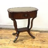 A Strongbow Furniture reproduction mahogany Georgian style work table, the oval top with central