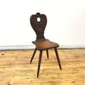 A late 19thc hall chair, the cartouche shaped back incorporating a pair of interlacing birds, with