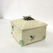 A 1930s Crown Devon lidded box, with a honeycomb pattern exterior and a bee finial, with single