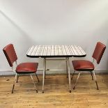 A 1950s breakfast set comprising a formica topped table with hinged flaps and tubular legs,