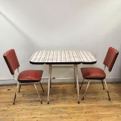 A 1950s breakfast set comprising a formica topped table with hinged flaps and tubular legs,