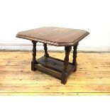 A mid century oak occasional table, the oblong top with canted corners and swivel mechanism raised