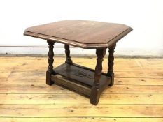 A mid century oak occasional table, the oblong top with canted corners and swivel mechanism raised