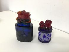 Two Peking glass seals, one of oval form, the other circular, both with lion dog finials (larger: