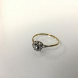 An 18ct gold and platinum mounted diamond set cluster ring (1.73g) (R/S)