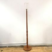 A teak standard lamp, with turned stem on circular base with moulded edge (h.142cm to top of lamp