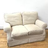 A two seater sofa in oatmeal upholstery, with loose cushions and scrolling arms (89cm x 140cm x