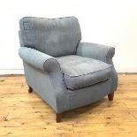 A modern easy chair, upholstered in peacock tweed fabric, raised on square tapering legs (91cm x