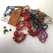 A collection of costume jewellery including a graduated malachite bead necklace, a coral bead
