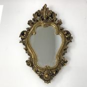 A modern cartouche style wall mirror, the glass plate within a gilt composition rococo style