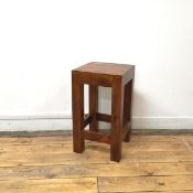 A hardwood stool, with square top on straight square section supports, with box stretcher (50cm x