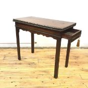 A George III mahogany tea table, the hinged rectangular top with edge carved with ribbons and