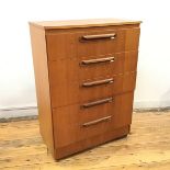 A Sakol Furniture teak veneered chest of drawers, the rectangular top over five drawers, on castors,