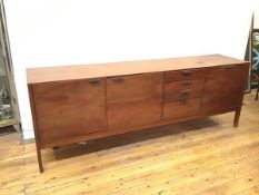A 1960s teak sideboard, with three cupboards, one with a fall front, and four drawers, one fitted