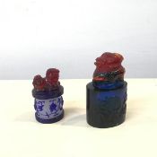 Two Peking glass seals, one of oval form, the other circular, both with lion dog finials (larger: