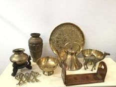 A collection of brassware including a kettle, footed bowls, a camel, a circular tray (d.43cm), a