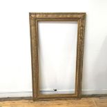 A gilt composite frame with foliate decoration (145cm x 83cm)