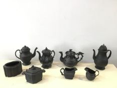 A group of 19thc black basalt tea wares including coffee pot, with domed cover, sprigged with