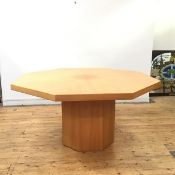 A modern octagonal dining table by Poggenpohl, the octagonal top with radiating veneers on a faceted