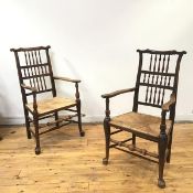 A near pair of 19thc Lancashire armchairs, both of mixed timber construction, the yoke shaped top