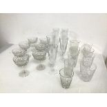 A set of seven crystal champagne coupes (h.11cm x d.8cm), five champagne flutes and nine