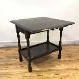 An oak pembroke table, the rectangular top with two drop leaves with carved gallery to either end,