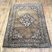 A Persian hand knotted wool carpet, the camel coloured field with central medallion outlined in
