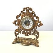 A mid 19thc gilt metal pocket watch stand, cast with rococo scrolls, later fitted with a clock (17cm