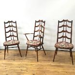 A set of six Ercol dining chairs comprising two carvers and four side chairs, all with yoke shaped