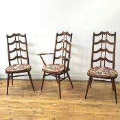 A set of six Ercol dining chairs comprising two carvers and four side chairs, all with yoke shaped