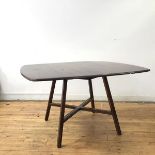 An Ercol elm drop leaf table, the rectangular top with moulded edge on splayed supports, united by
