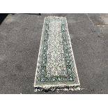 A hand knotted wool runner, made in North Africa, the ivory field allover decorated with