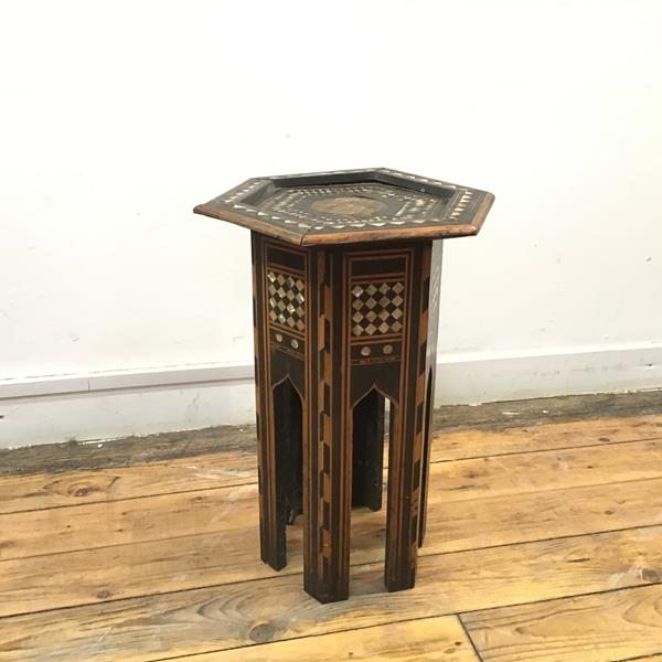 A Middle Eastern hexagonal occasional table with dished top and inlaid with ebony and mother of