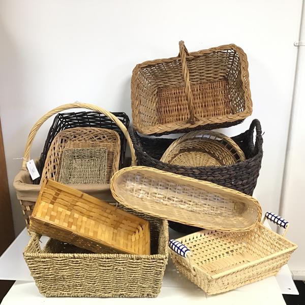 An assortment of wicker ware including bread baskets, two handled baskets, a basket with ceramic