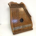An early 20thc piano chord stamped Made in Germany each strings' notes marked by a scale along the