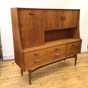 A 1960s teak G Plan side cabinet, the raised superstructure incorporating a fall front drawer and