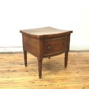 A Regency mahogany commode, the hinged bow fronted top above a false drawer, on turned tapering legs