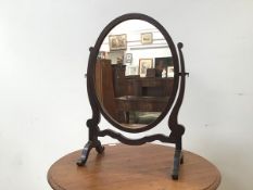 An oval dressing table mirror on stand (61cm x 40cm x 23cm)
