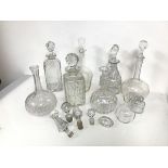 A collection of seven cut crystal decanters, in various forms (largest: h.26cm x 10cm x 10cm),