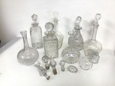 A collection of seven cut crystal decanters, in various forms (largest: h.26cm x 10cm x 10cm),