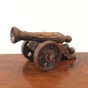 A carved pine model of a canon, first half of 20thc. of typical form, with carved barrel and