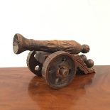 A carved pine model of a canon, first half of 20thc. of typical form, with carved barrel and