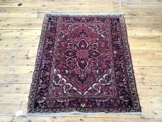 A Hamadan rug, the madder field with stylised floral medallion within ivory and blue spandrels and