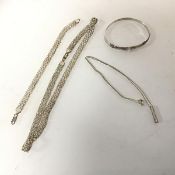 A silver chain with a vertical bar pendant, a silver fancy link chain necklace with matching