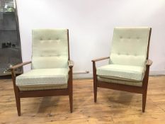A pair of Cintique armchairs with green tone geometric pattern upholstery, the button backs over a